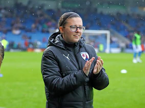 A shot of Alyss Jackson, coach in Women's Walking Football, applauding as she coaches a session inside Chesterfield's stadium.