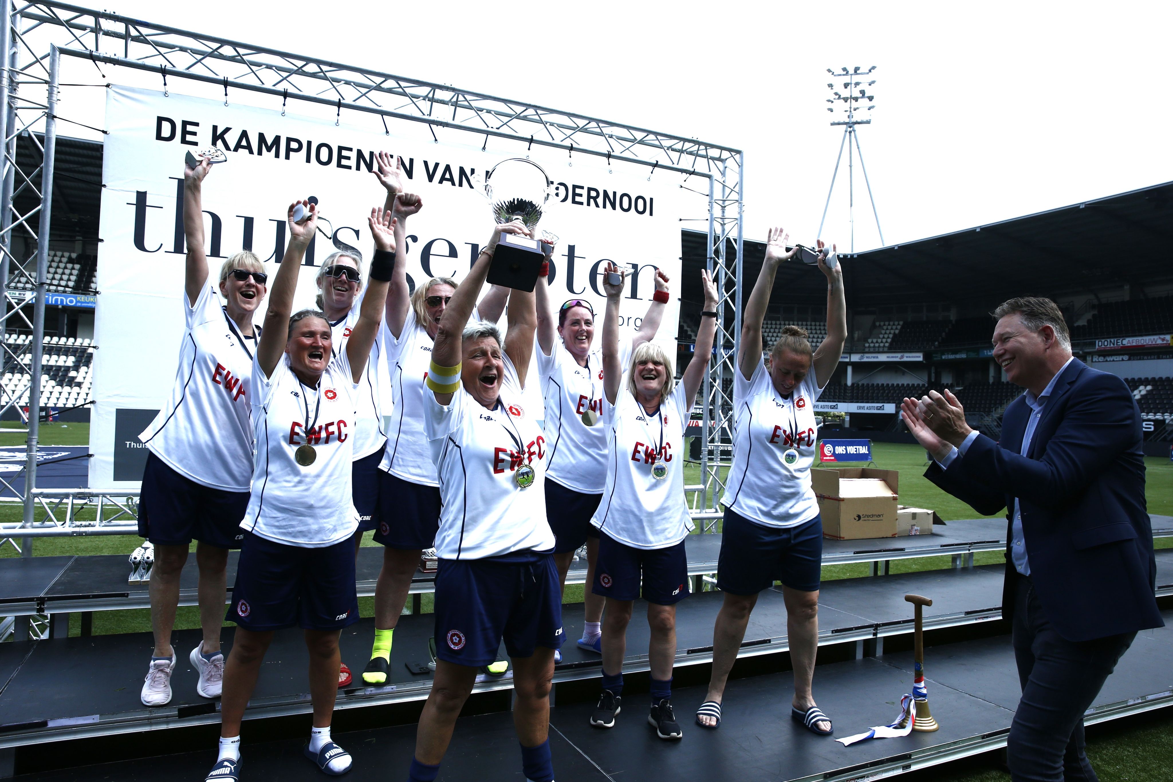 A shot of a female team lifting the Almelo City Cup - an international Walking Football tournament.